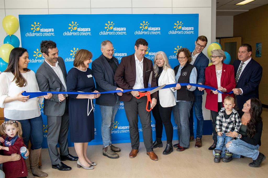 A group of people at a ribbon cutting ceremony